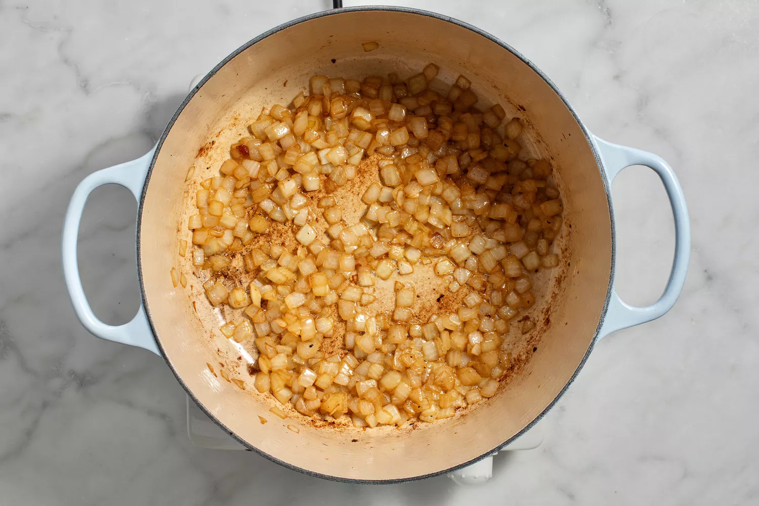 onion sauteeing in pot with oil