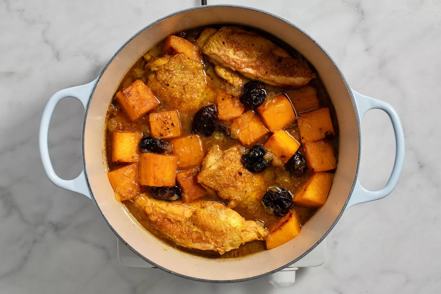 remaining spices, plus butternut squash and prunes added to pot with chicken