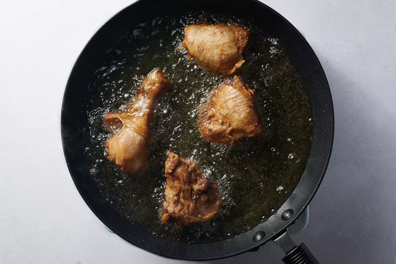 chicken frying in oil