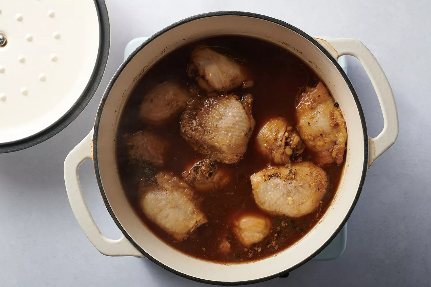 chicken cooked in broth in a stock pot