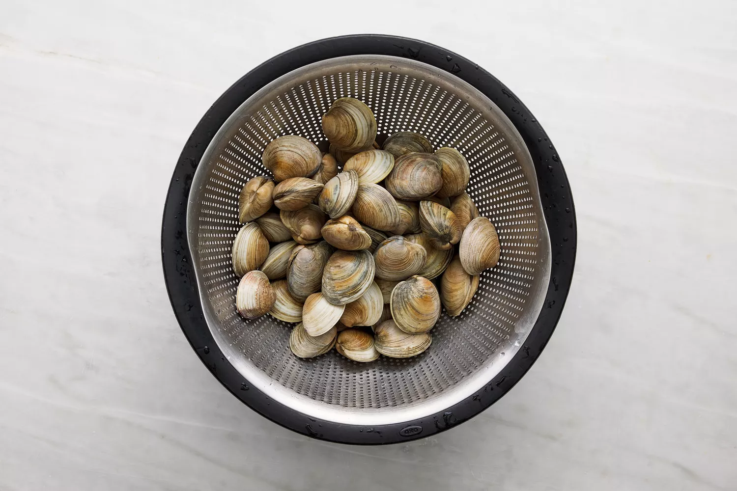 purged clams draining in collander