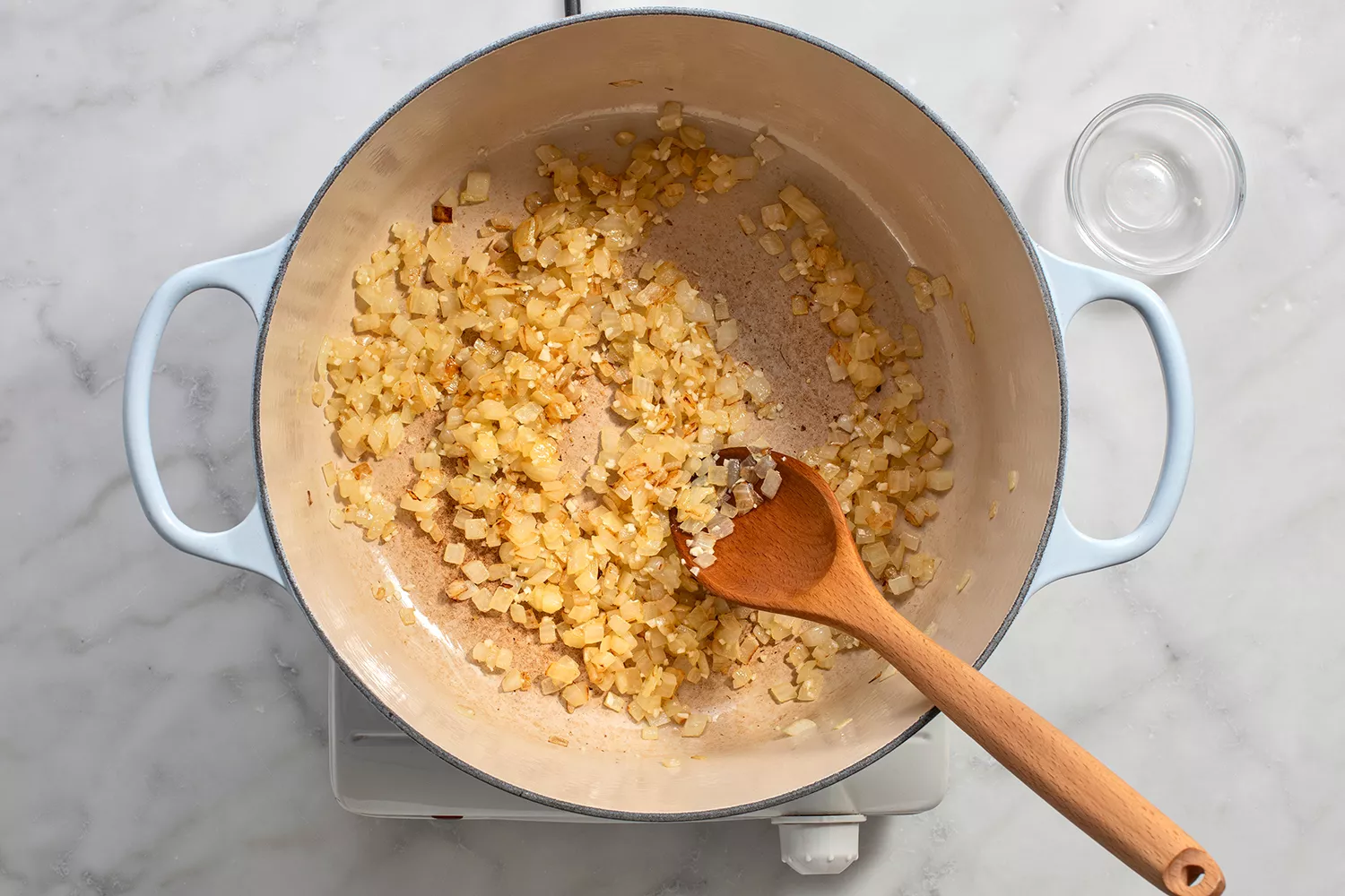Onion and garlic cooking in a dutch oven