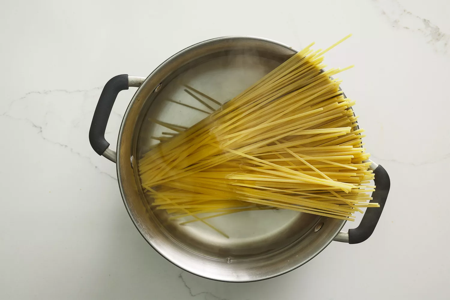 A large pot of water with fettuccine pasta